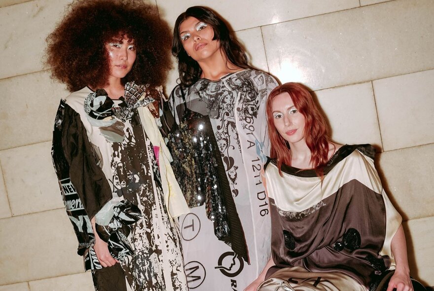 Models wearing patterned scarves and robes.