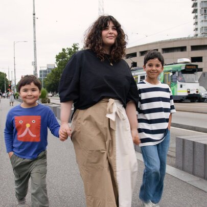 Julia and her two kids walking across Princes Bridge