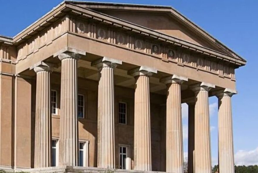Greek Revival classical building with portico and pillars.