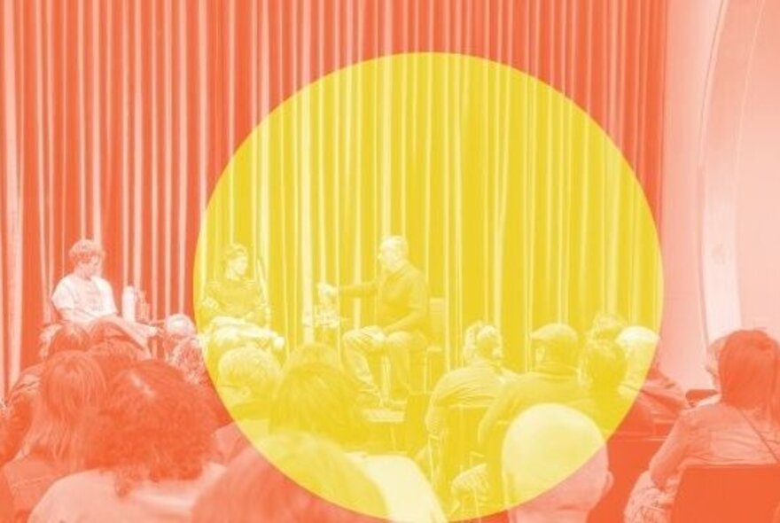 A brightly lit stage with a curtain as a backdrop, with three people in a panel discussion seated facing an audience; there is large yellow circle superimposed over the orange coloured image. 