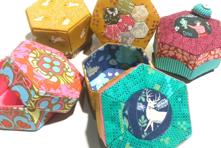 A selection of hand crafted 3D trinket boxes using English paper piecing quilting techniques.