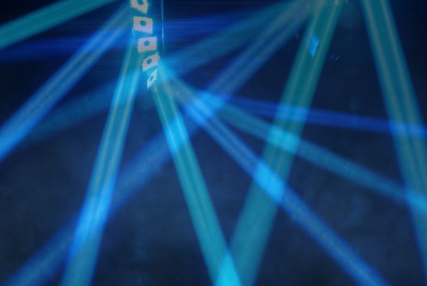 Beams of blue light criss-crossing each other.