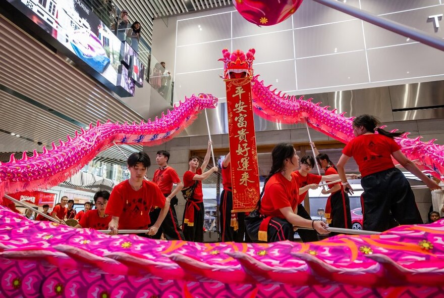 A lion dance performance and drumming taking place at Emporium Melbourne shopping centre, to celebrate the lunar new year.