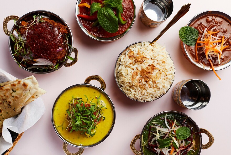 Indian feast served in little metal bowls.