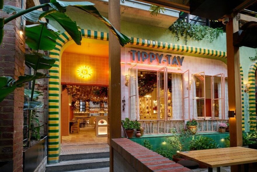 A colourful restaurant entrance with Tippy Tay written on front.
