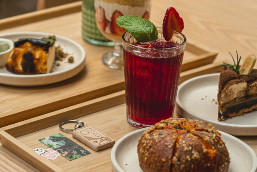 A selection of Japanese-inspired desserts with a strawberry tea on bamboo trays.