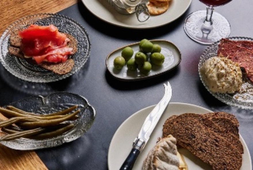 Looking down at a table with various small plates of food. 