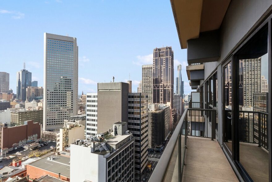 View from hotel balcony of city buildings and streets.