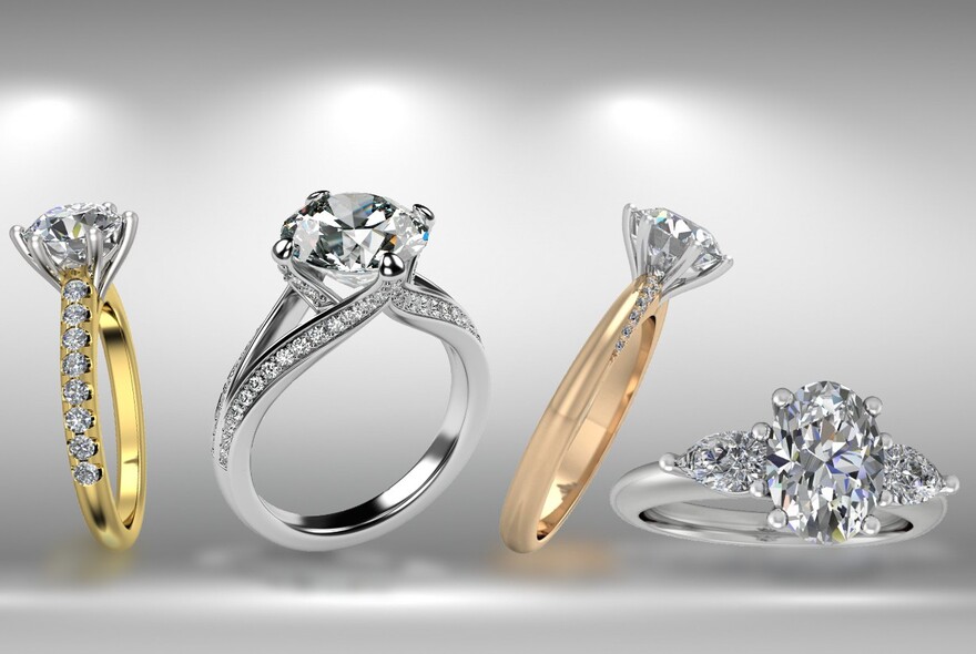 Four diamond engagement rings in gold, platinum and rose gold.