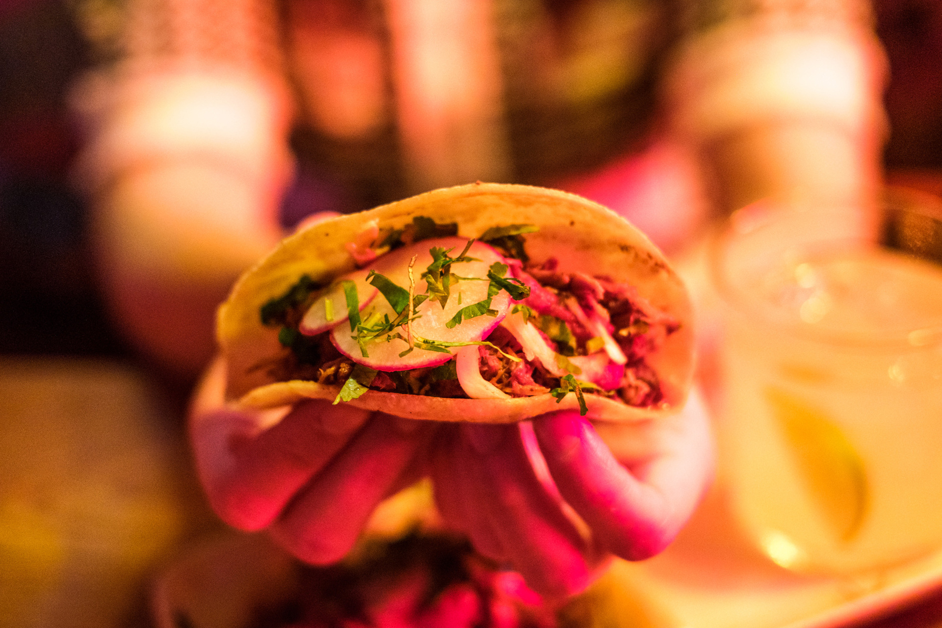 A person is holding a taco