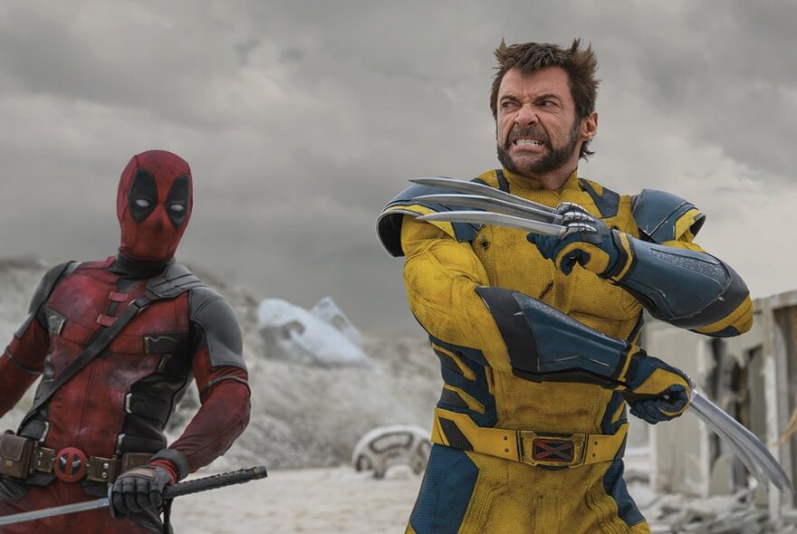 Film still of the characters from the Marvel films Wolverine and Deadpool on set in action. 