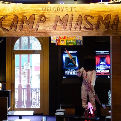 Camp Miasma bar theme sign and props.