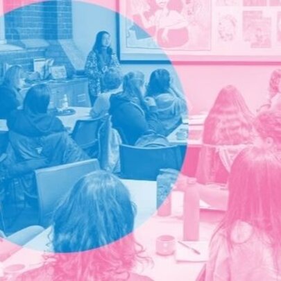 People seated at tables listening to a speaker who stands at the front of a room; the image is stylized with a dual-tone colour filter, a blue circle over a pale pink wash.