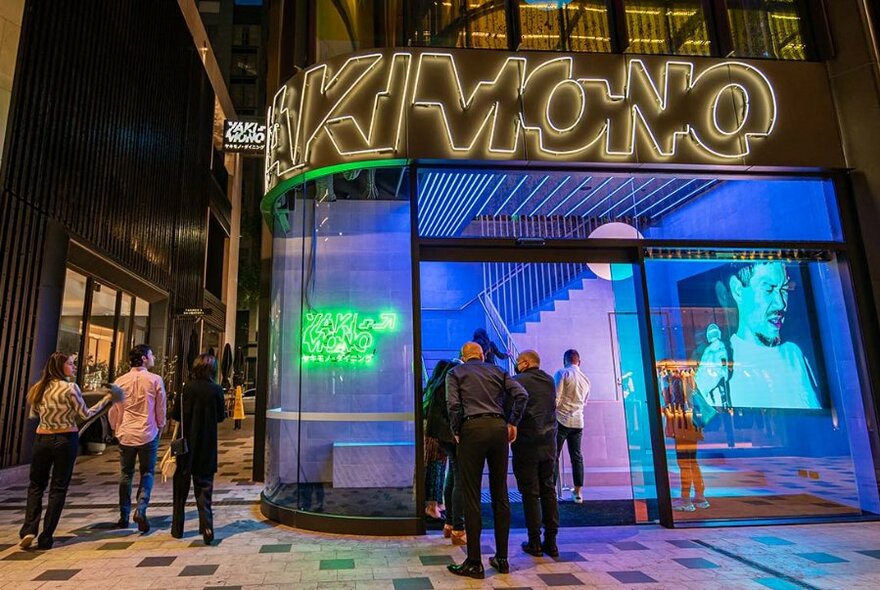 Neon-lit entrance to Yakimono restaurant.