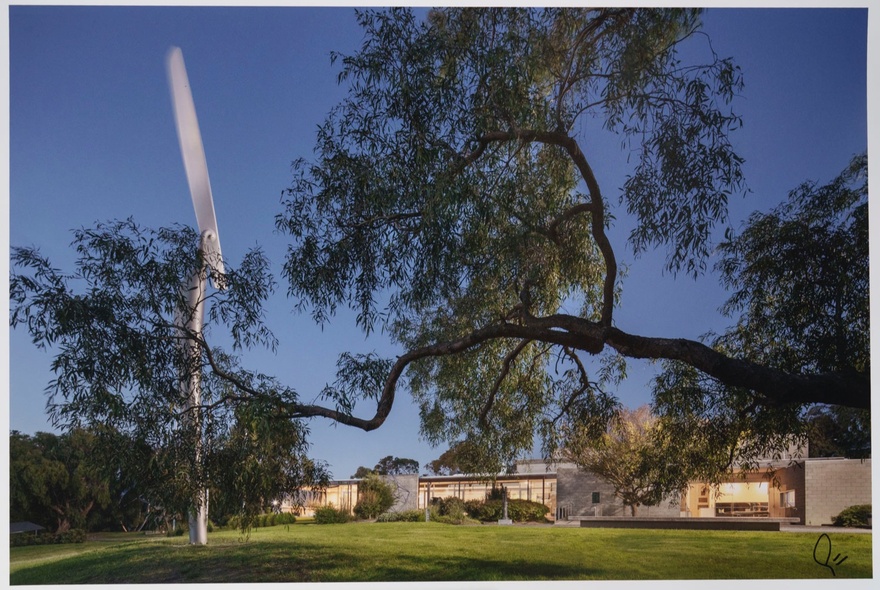 Photo of houses surrounding a park and metal sculpture.