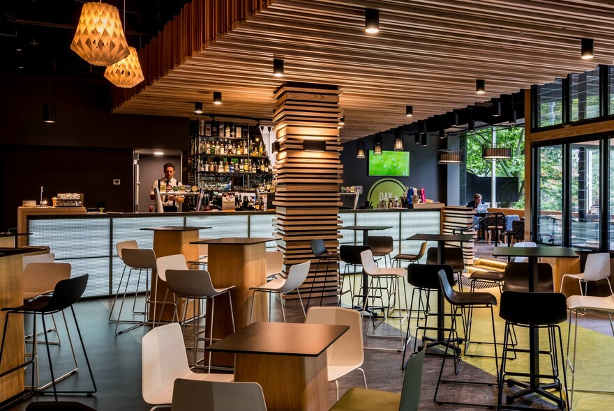 Empty interior of Oak & Vine showing tables, chairs and the bar.