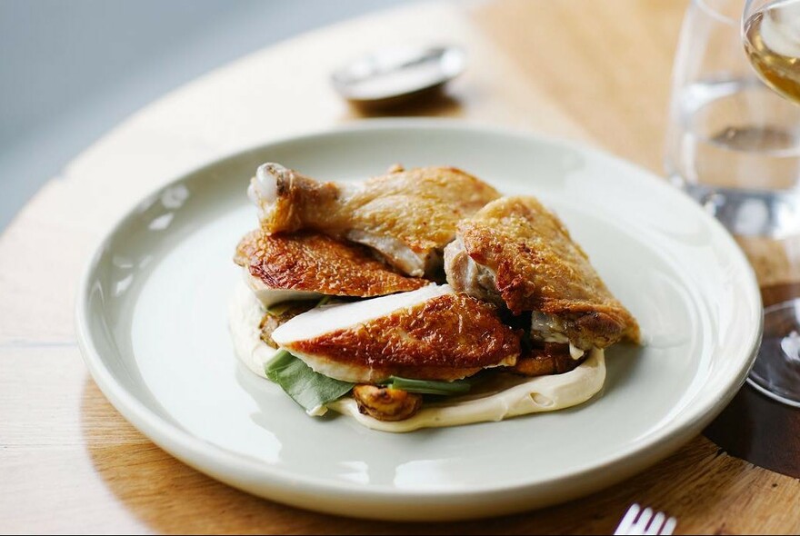 Roast chicken pieces on a plate.