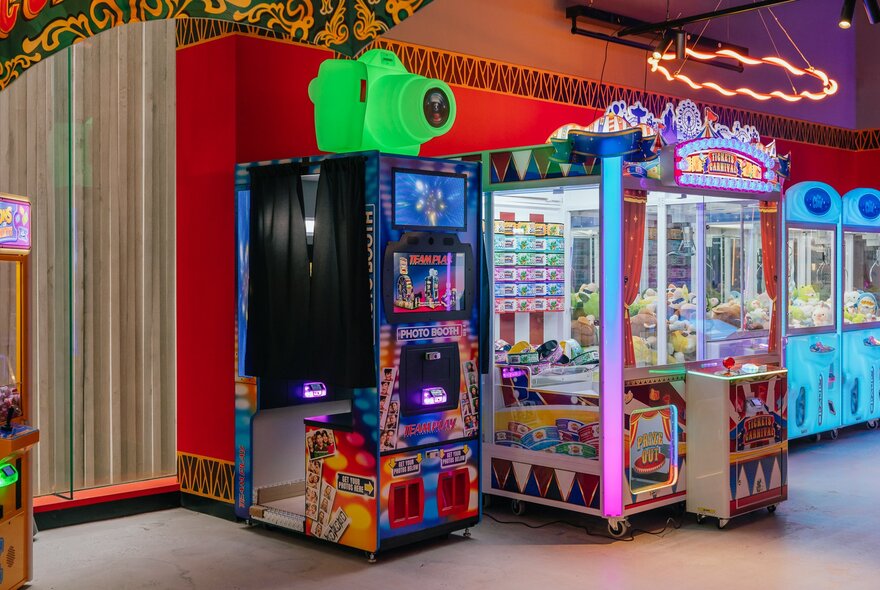 Brightly coloured interior of Archie Brothers showing a claw arcade games in glass booths.
