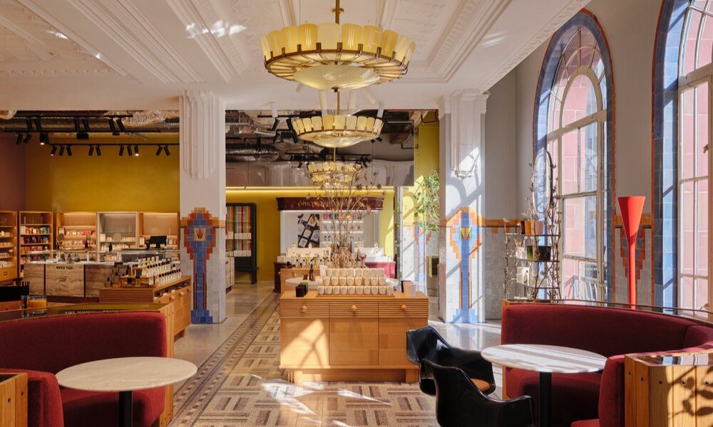 A perfume store with an art deco interior and large arch windows.