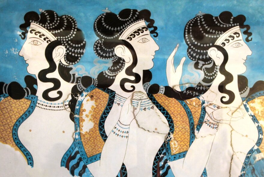 Ancient blue, black and white painting of three women on a ceramic vase.