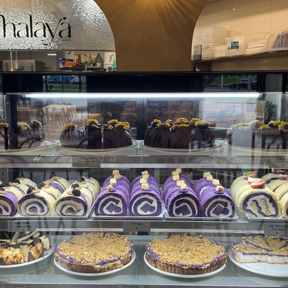 Display case of cakes and tarts in a cafe.