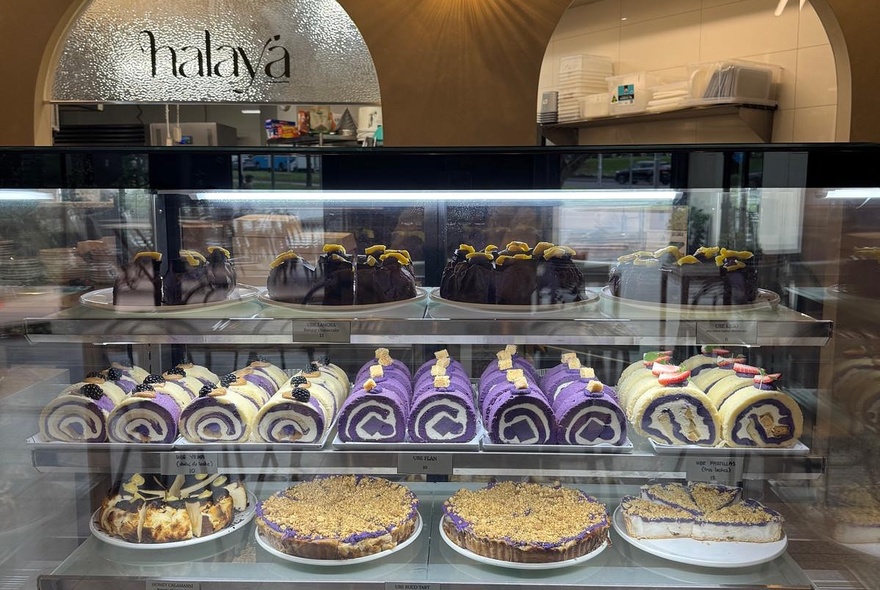 Display case of cakes and tarts in a cafe.