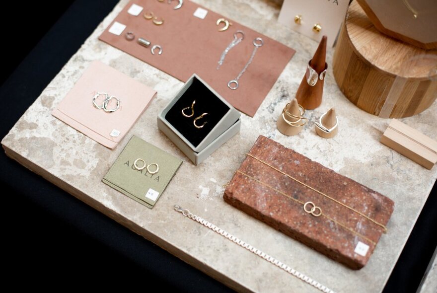 A display of delicate earrings and chains on a table.