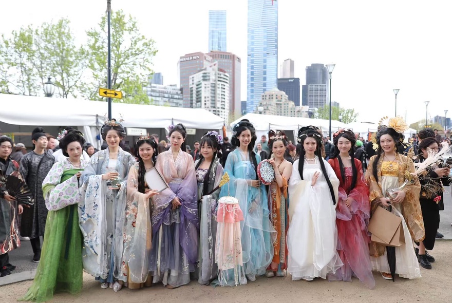 A lineup of women in Chinese tradtional flowing dresses.