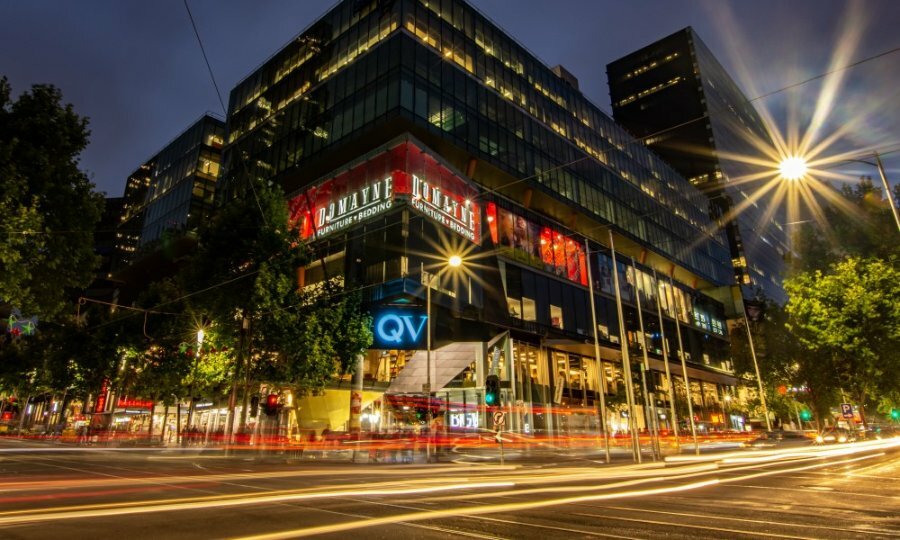 QV shopping centre at night with lots of bright lights.