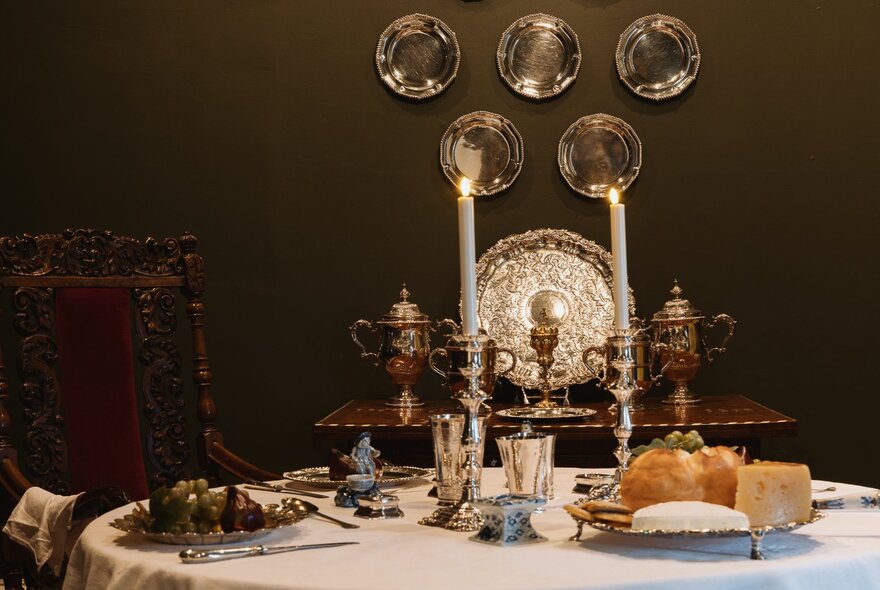 Formal table setting with antique candlesticks and tableware.