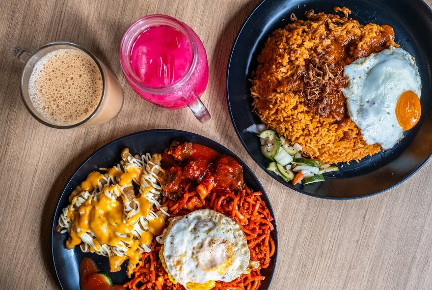 Two rice and egg dishes and two colourful drinks.