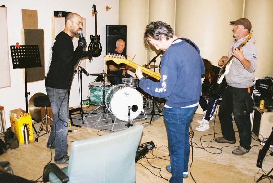 The four-piece band Eddie Current Suppression Ring playing music in a recording studio. 
