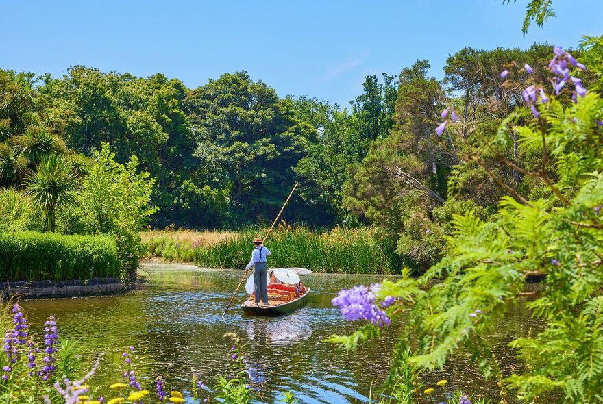 A man is punting on a lake i