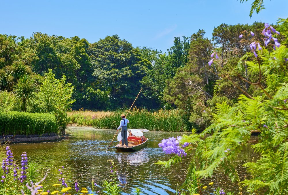 A man is punting on a lake i