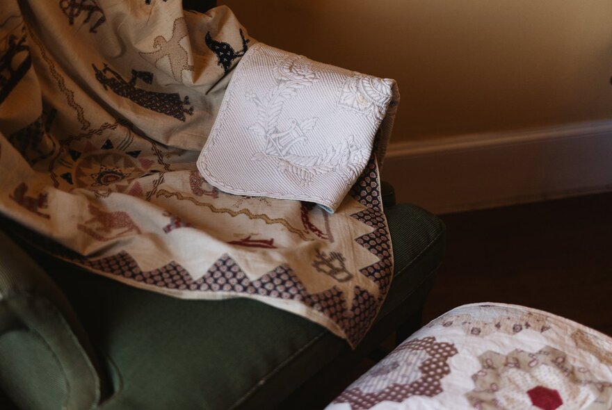 Detail of quilts and embroidered fabric.