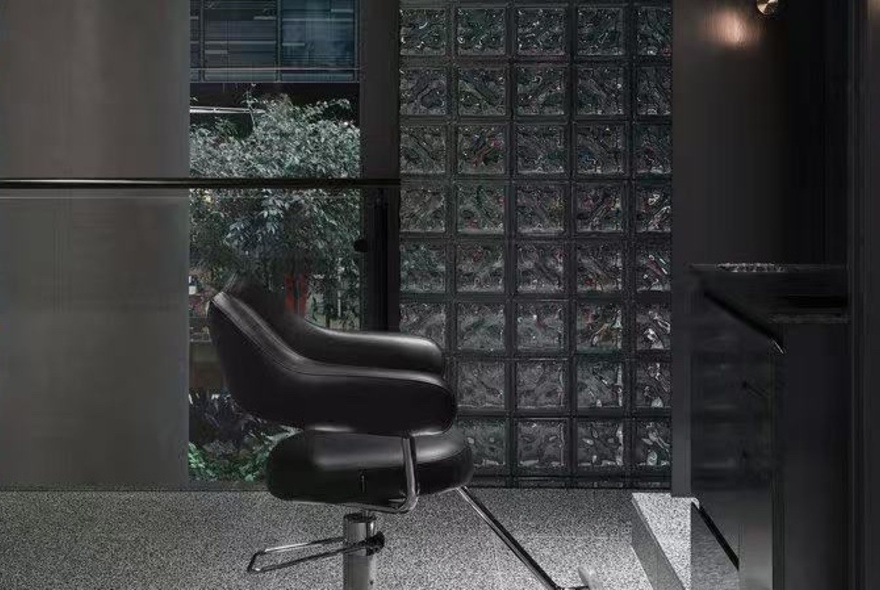 A black swivel chair in a hairdressing salon.
