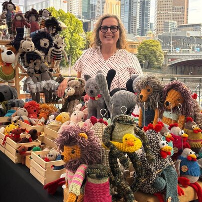 Market stallholder with her puppet toys, beside the Yarra River in the CBD.