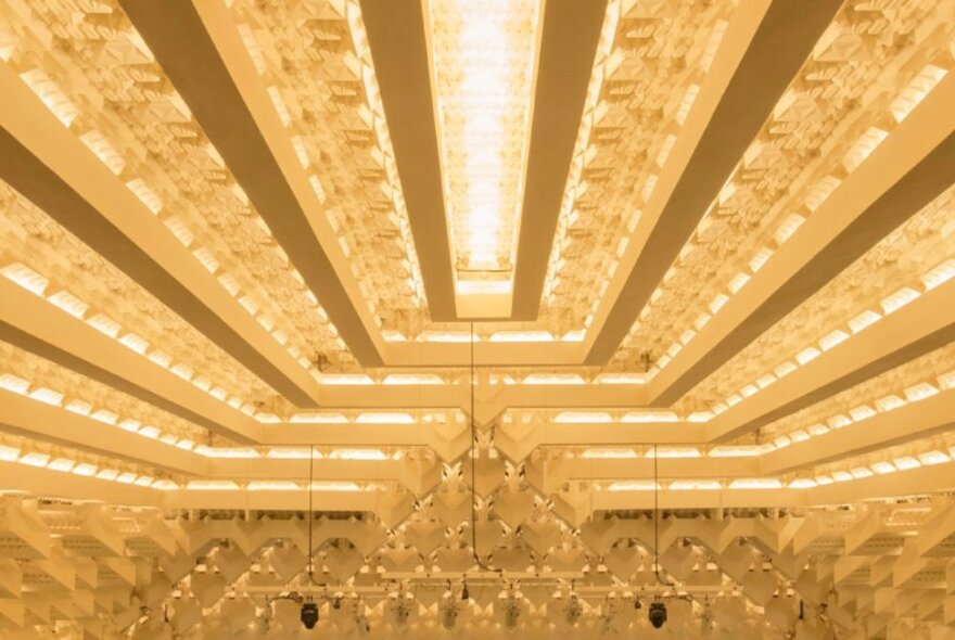 The golden-lit Art-Deco interior ceiling of The Capitol Theatre in Melbourne.