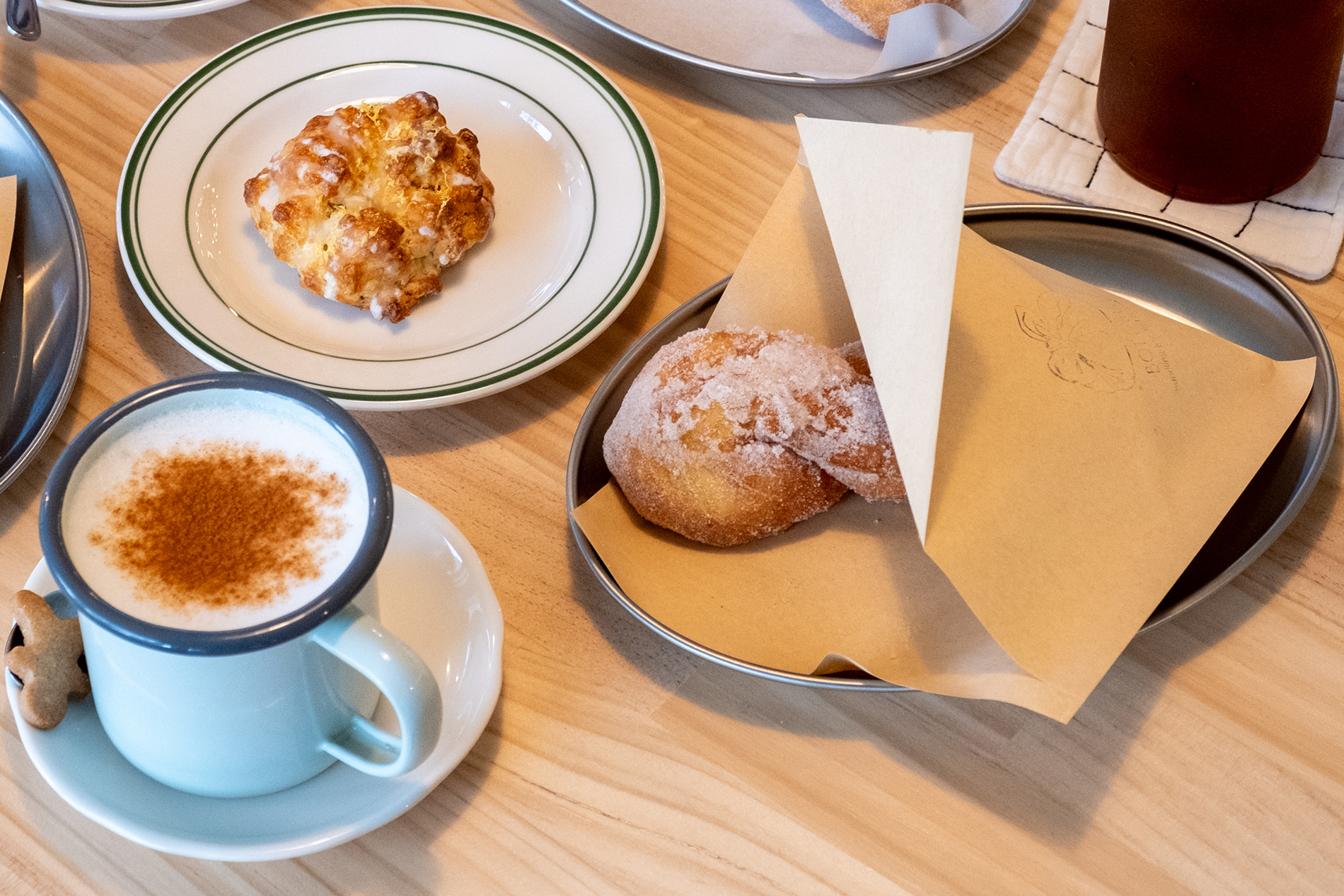 A cafe spread of doughnuts and coffee.