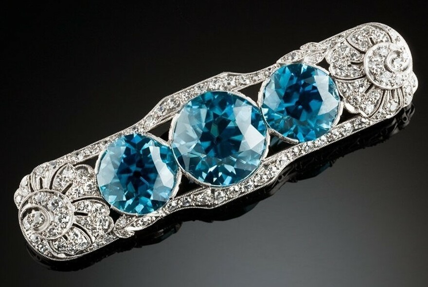 Close-up of antique diamond and aquamarine deco brooch.