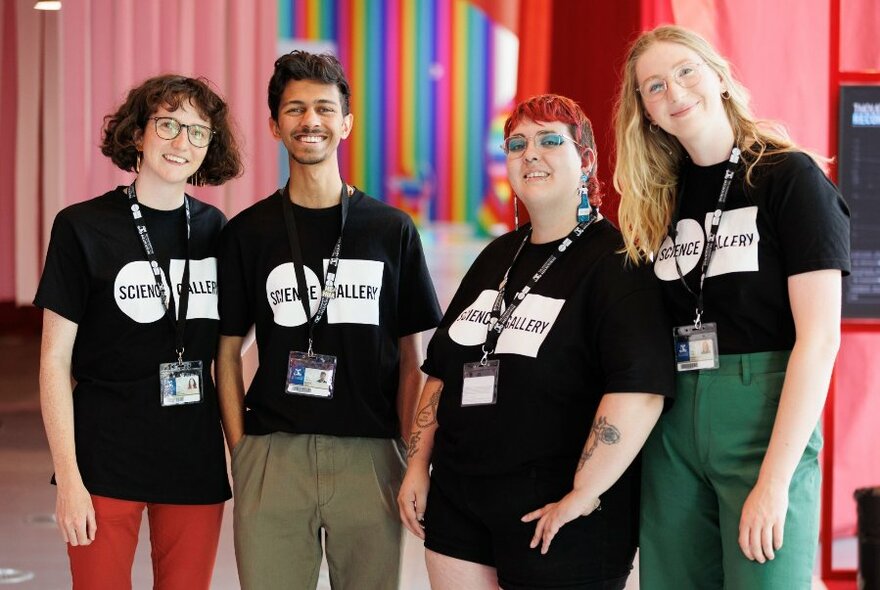 Gallery staff standing in the colourful pink foyer.