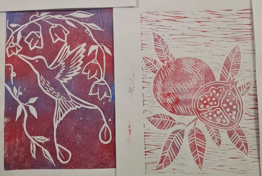 Two linocut prints, one of a red pomegranate fruit and the other of a hummingbird, on white paper.