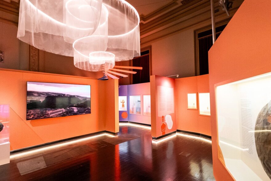 Installation view of an exhibition at Hellenic Museum in Melbourne, showing artworks on the walls.