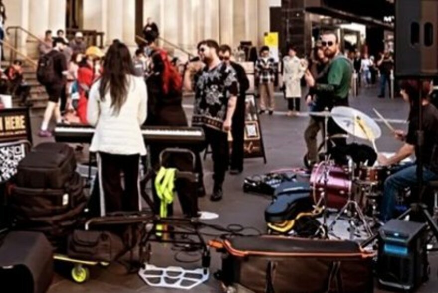 Street performers setting up with their instruments on Bourke Street Mall in Melbourne.