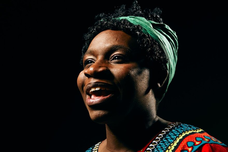 A close up of a woman on stage playing reknowned jazz singer and civil rights activist, Nina Simone.