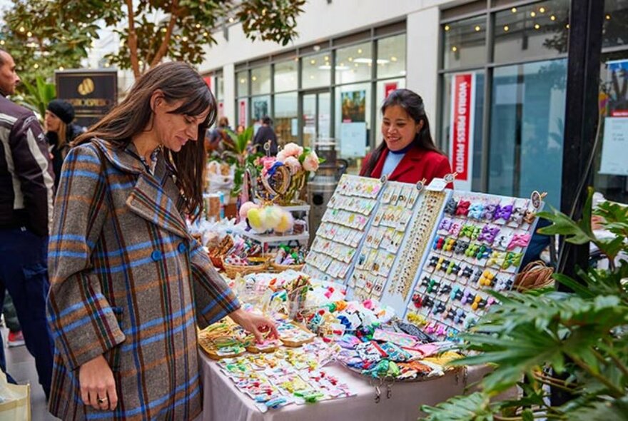 Woman looking at items at a market stall.