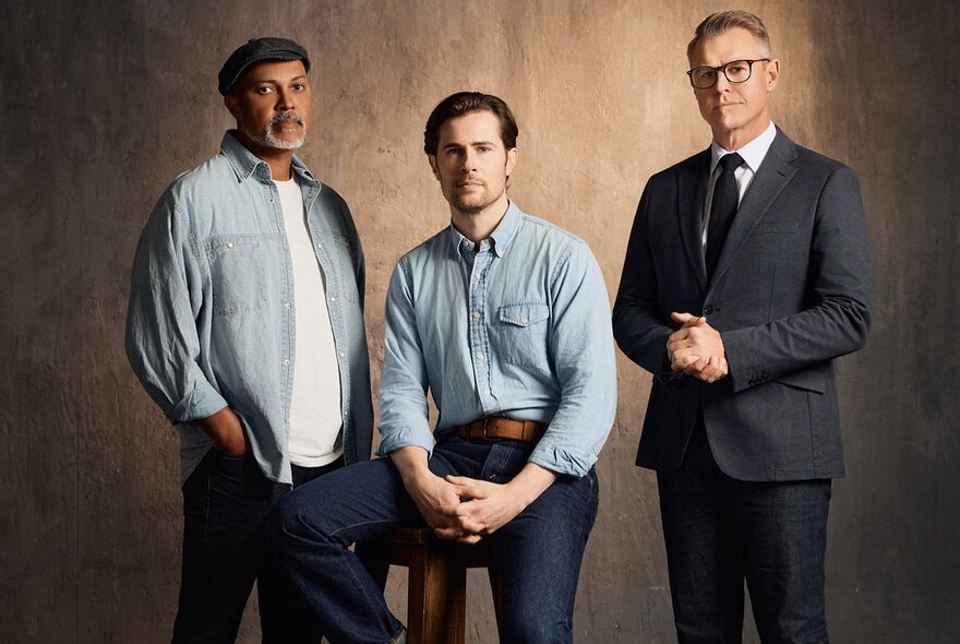 Three male actors - Rodger Corser, David Berry and Bert LaBonté - the lead cast for the stage adaptation of The Shawshank Redemption, posed against a light tan backdrop.
