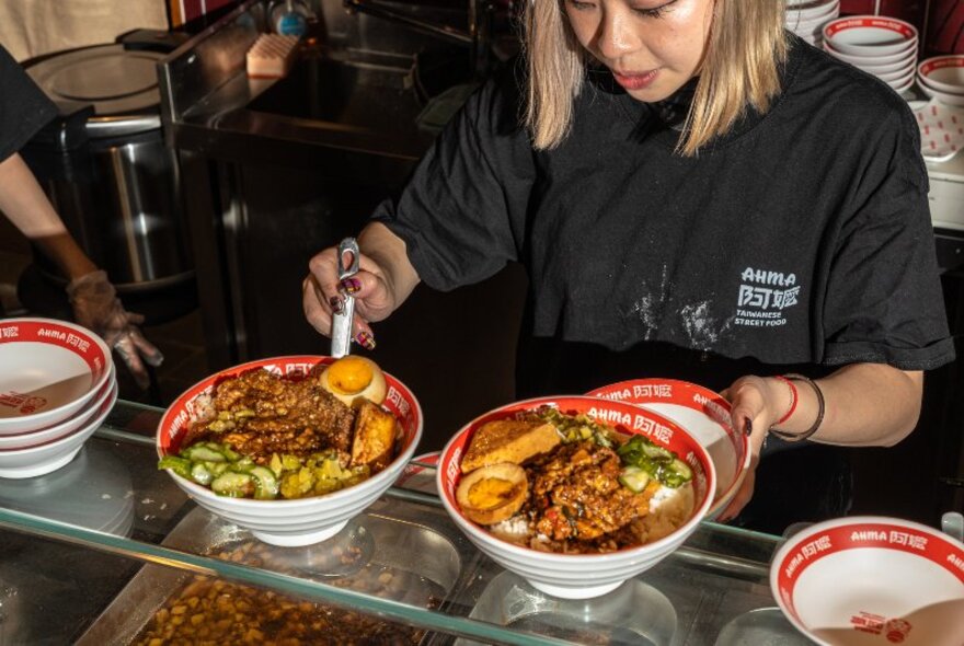 A chef serving up bowls of Taiwanese food. 