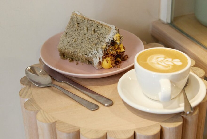 Coffee and cake on a round wooden table.  