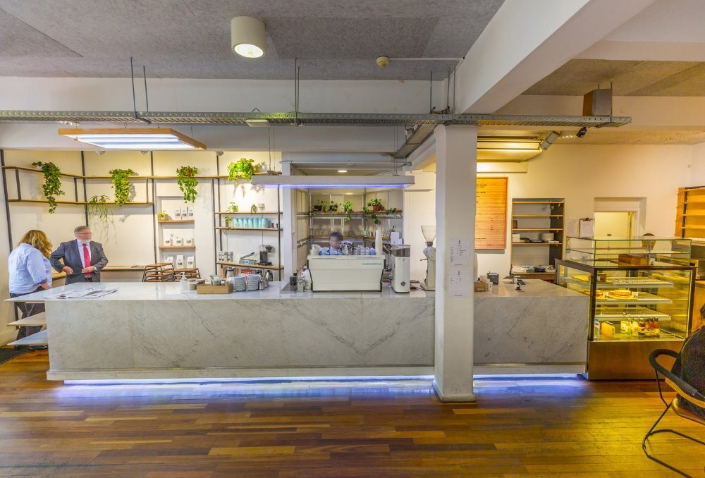 Marble counter of cafe with coffee machine in the middle.